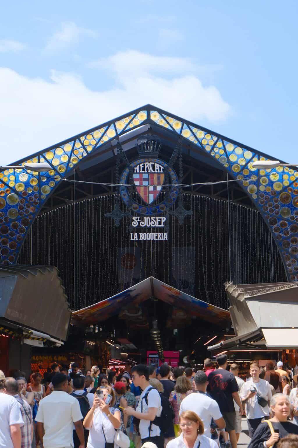 Exterior view of Flying Pig Downtown Hostel in Amsterdam with vibrant design and crowd.