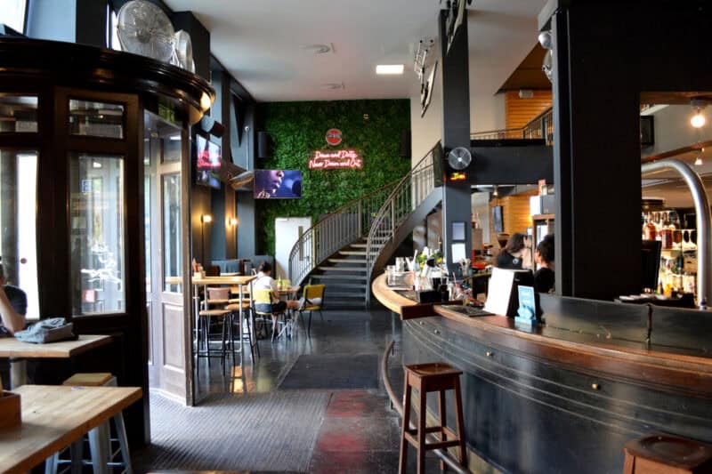 Flying Pig Downtown hostel interior with modern decor and bar area.
