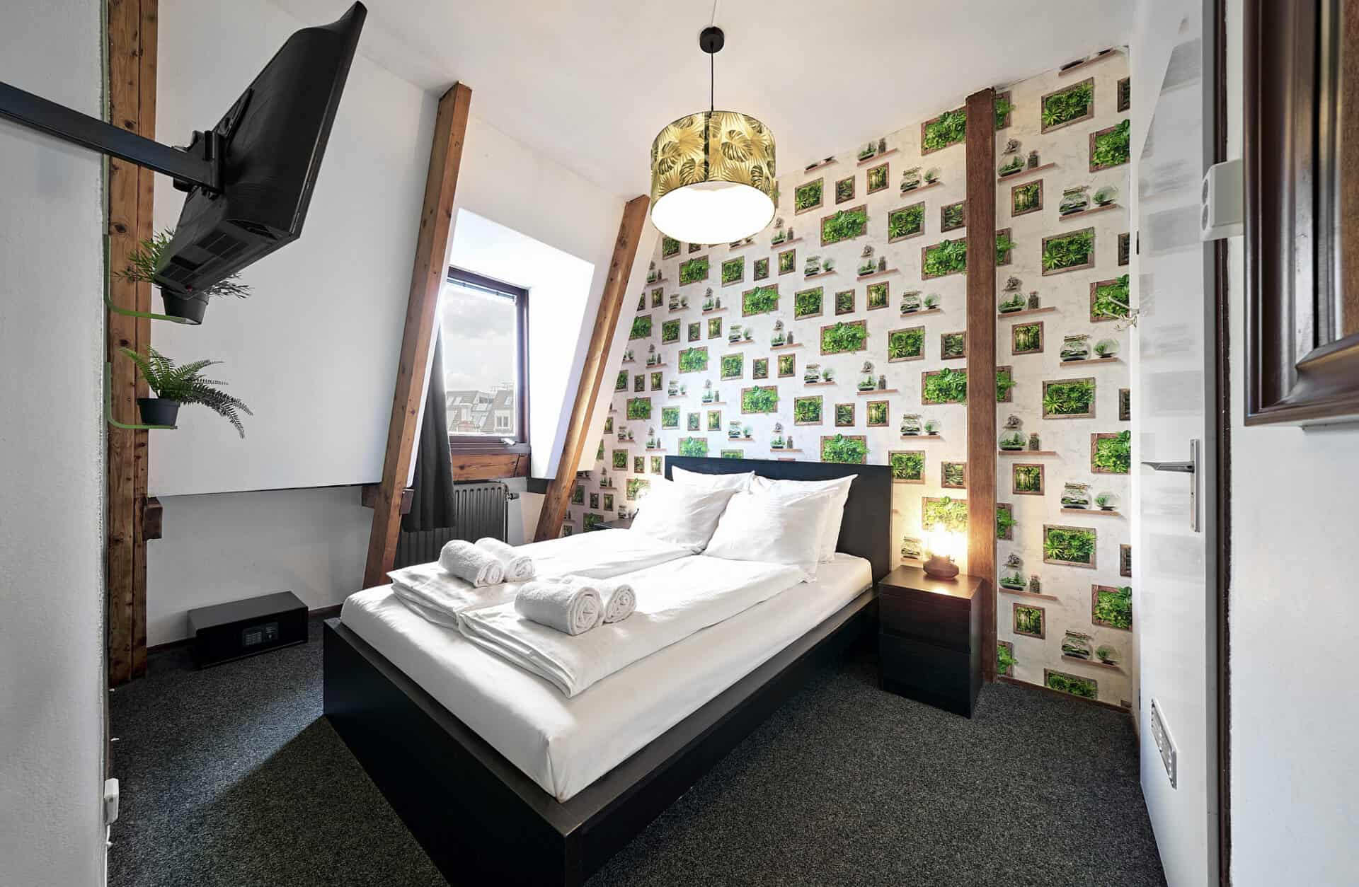 Comfortable hostel room with green wall decor and modern furnishings at Flying Pig Downtown.