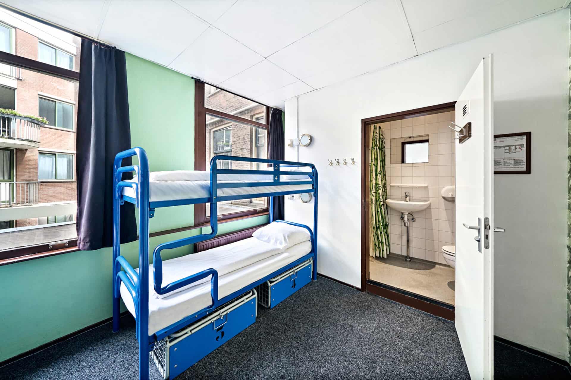 Dormitory room with bunk beds at Flying Pig Downtown Hostel in a vibrant city location.