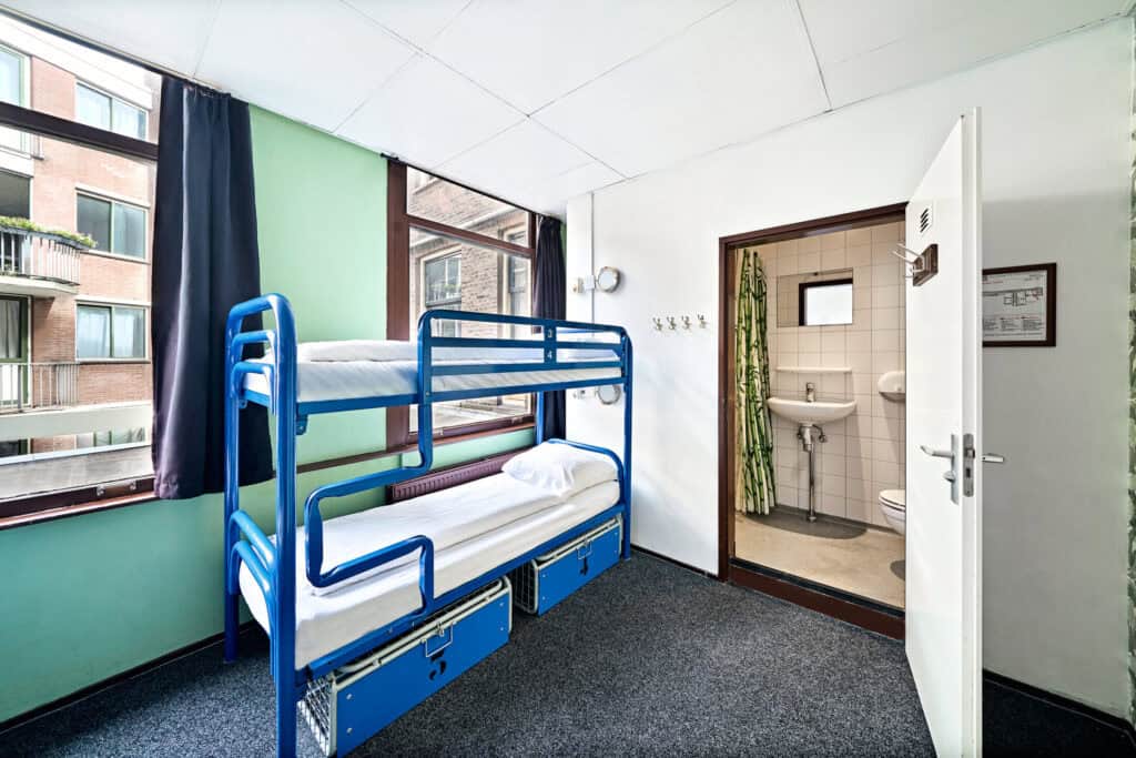 Dormitory room with bunk beds at Flying Pig Downtown Hostel in a vibrant city location.