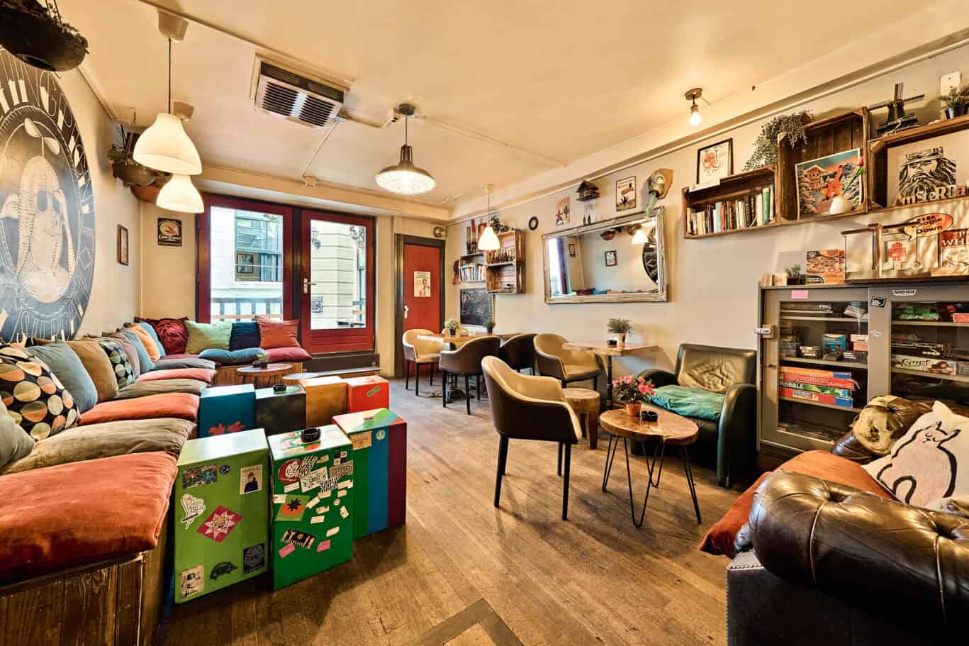 Interior of the cozy lounge at Flying Pig Downtown Hostel with colourful seating and wall decor.