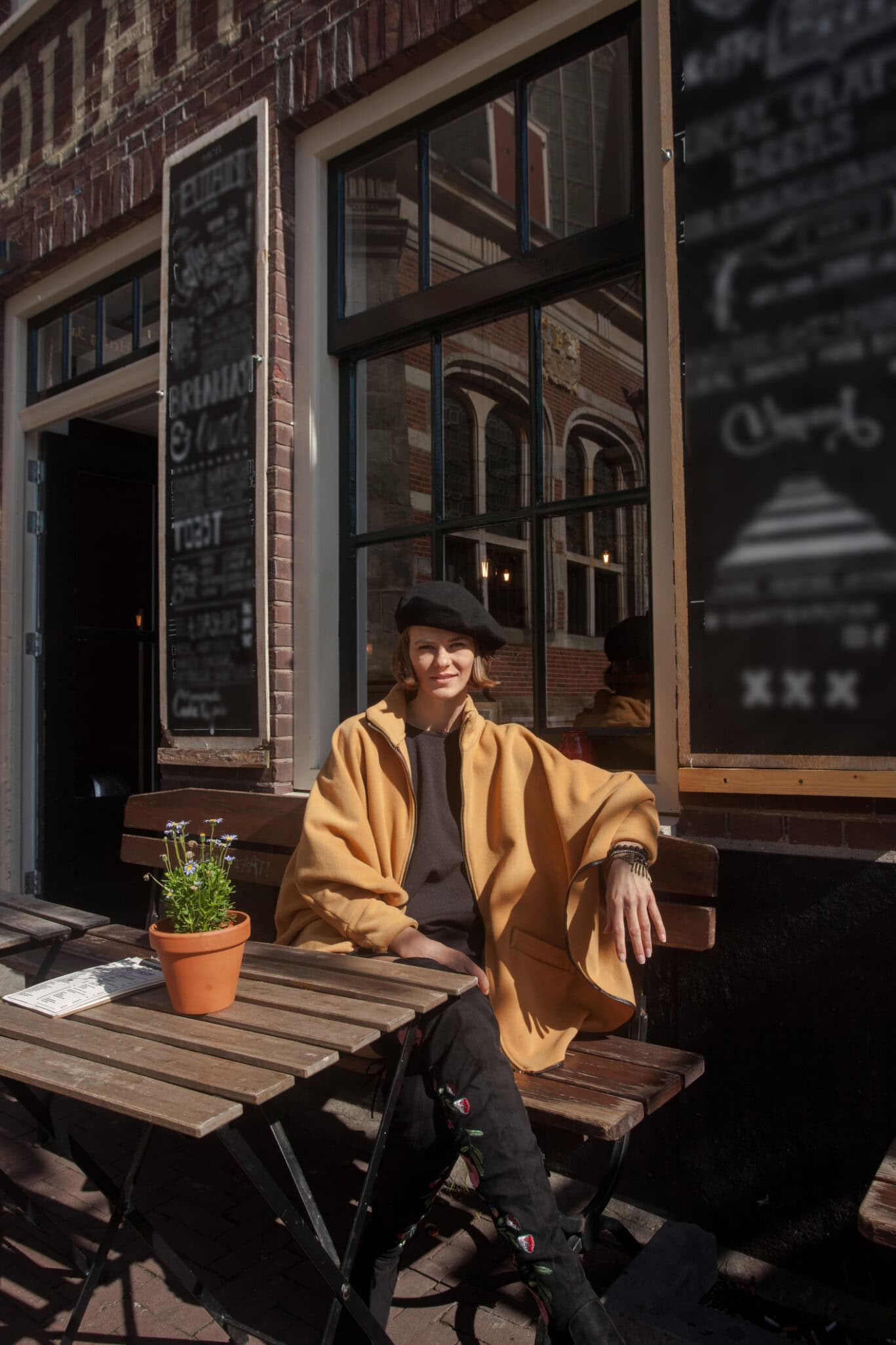 Solo traveller enjoying the outdoor terrace at The Flying Pig Downtown hostel in Amsterdam.