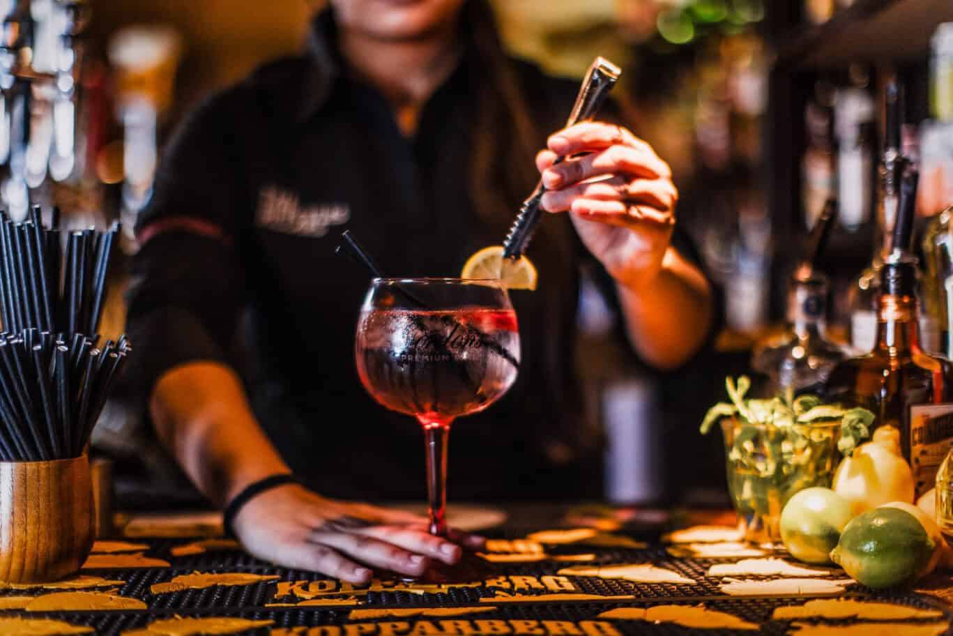 Vibrant cocktail being prepared at the bar.