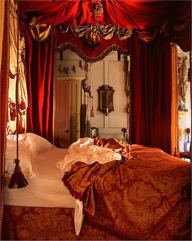 Interior of a luxurious room at St Christopher's Liverpool Street hostel, with ornate drapes and a 4.
