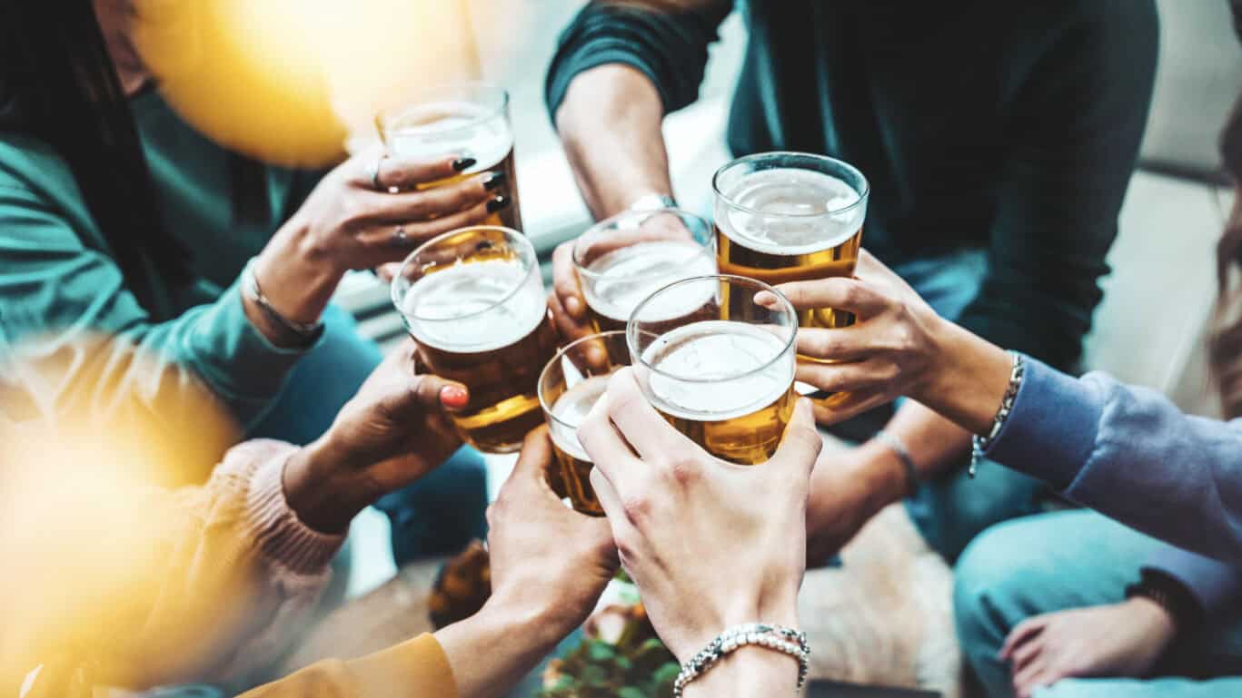 Social space at St Christopher's Liverpool Street hostel with travellers enjoying drinks.