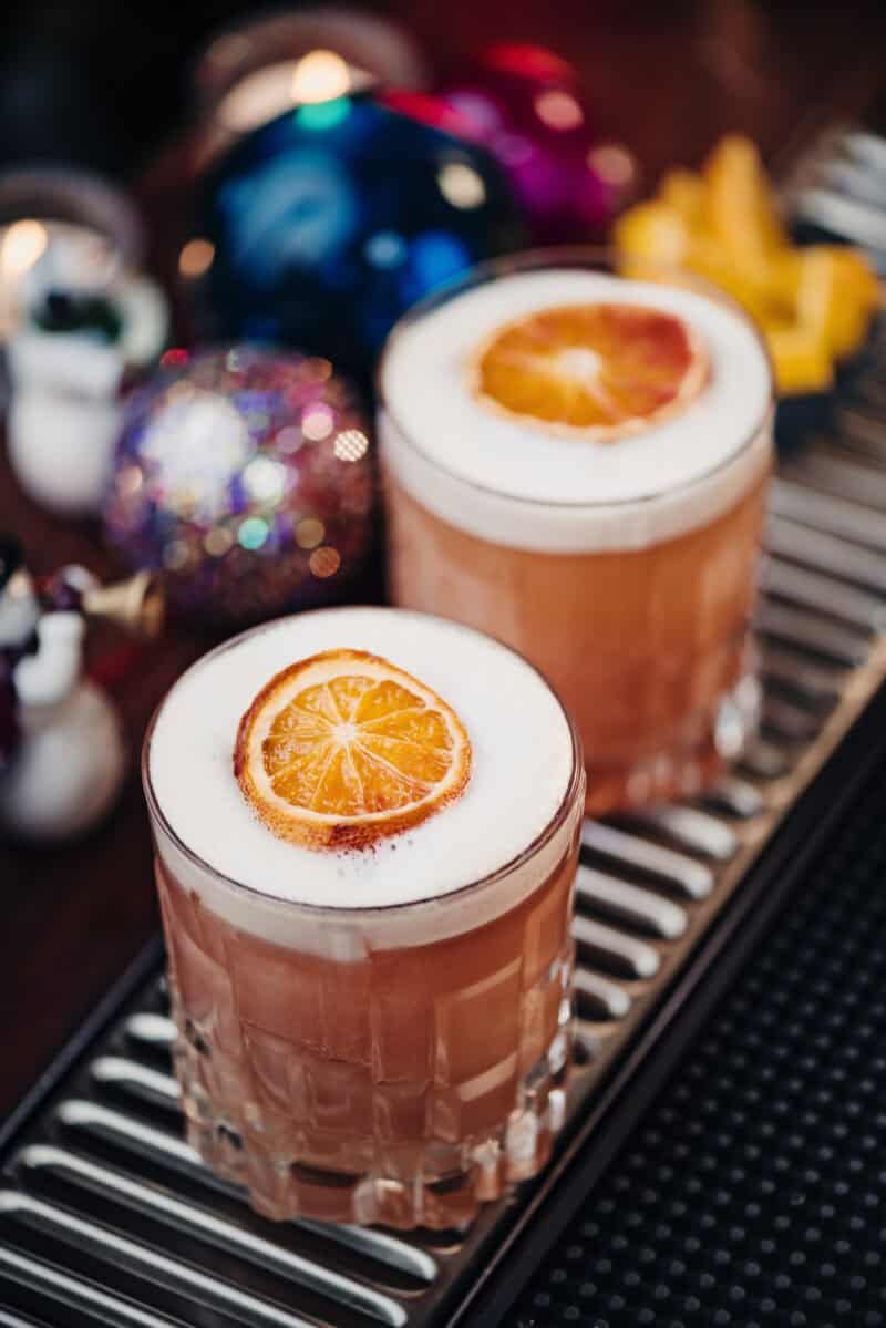 Two cocktails with orange slices at St Christopher's Liverpool Street hostel bar.