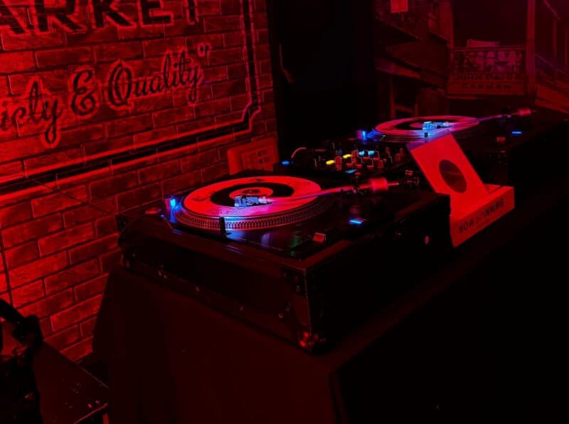 DJ setup at St Christopher's Inn London Bridge - The Inn with turntables and mixer in a dimly lit, b.