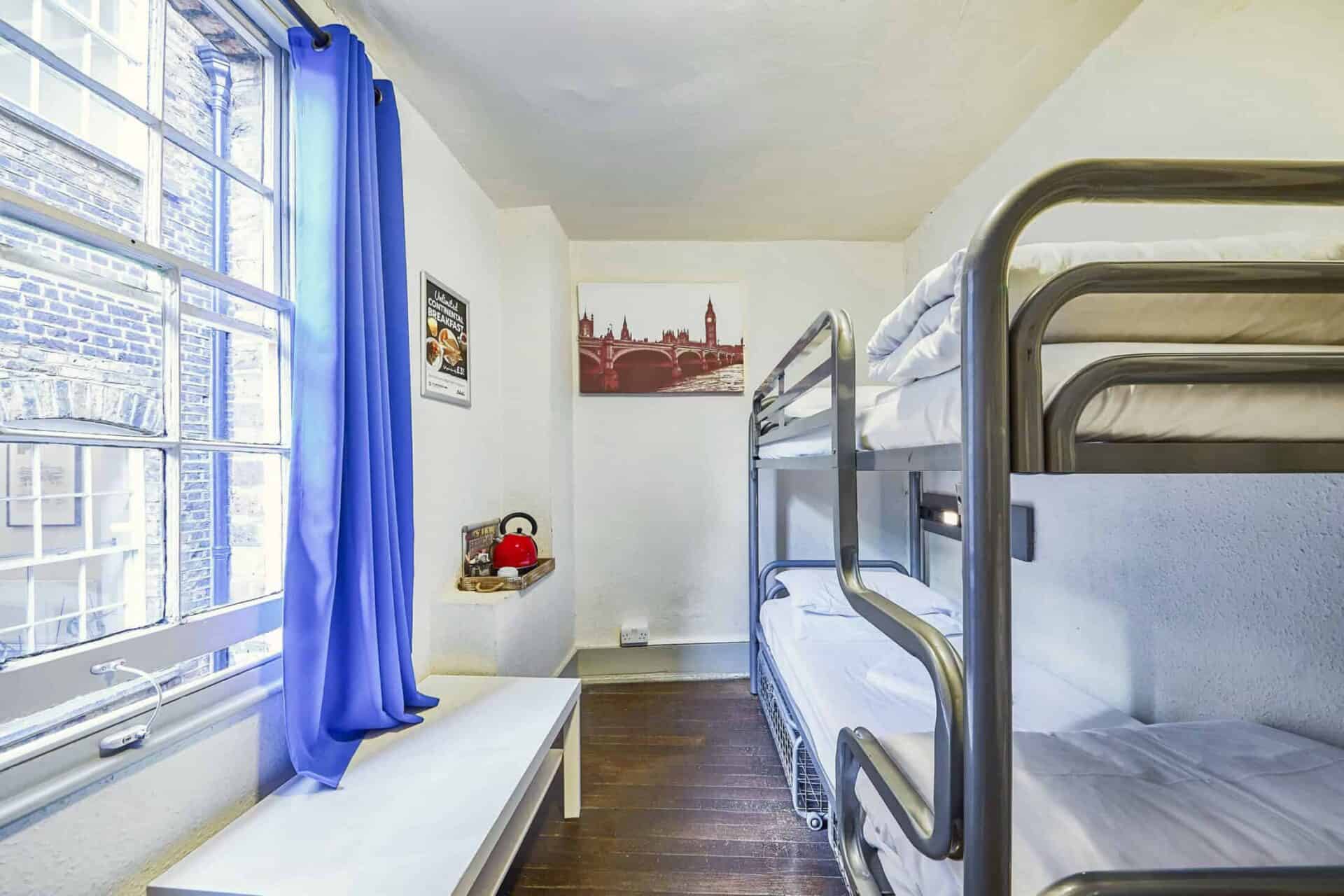 Room at St Christopher's Inn London Bridge - The Inn with bunk beds and a window with blue curtains.