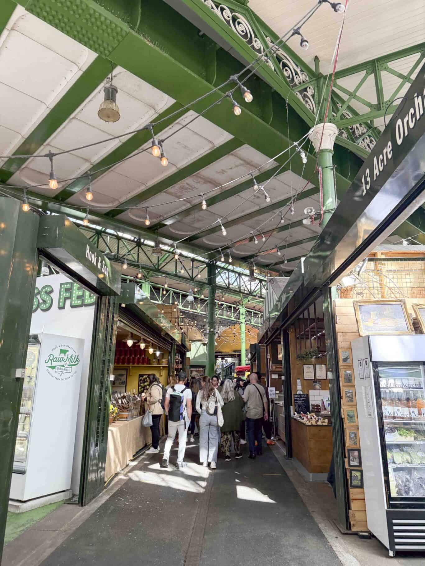 St Christopher's Inn London Bridge - The Inn at Borough Market arcade entrance with shoppers.