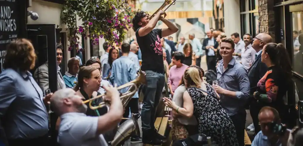 Street music ensemble outside St Christopher's Inn London Bridge - The Inn in Borough area.