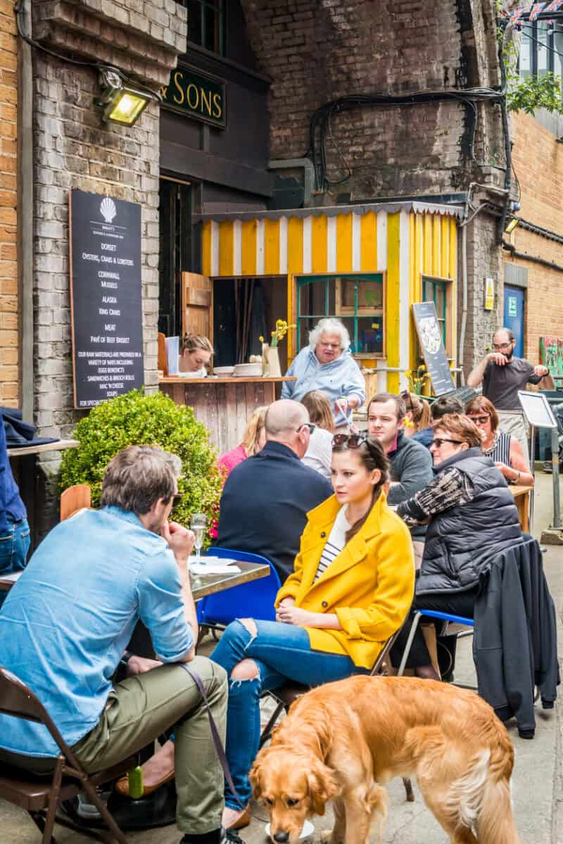 St Christopher's Inn London Bridge - The Inn outdoor cafe with guests and a dog.