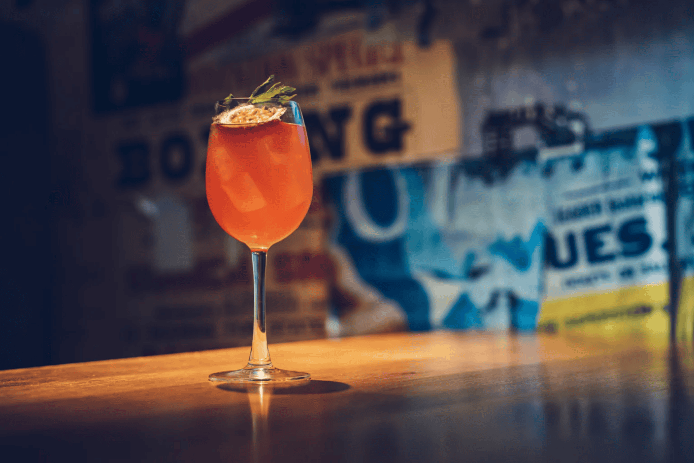 A colourful cocktail served in a tall glass at St Christopher’s London Bridge Hostel bar.