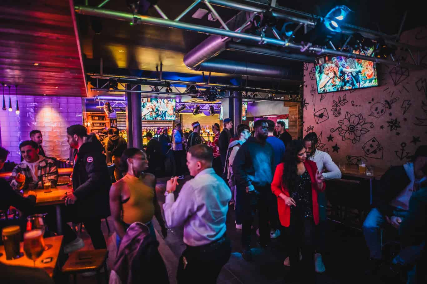 Vibrant social scene at St Christopher's London Bridge hostel bar in London.