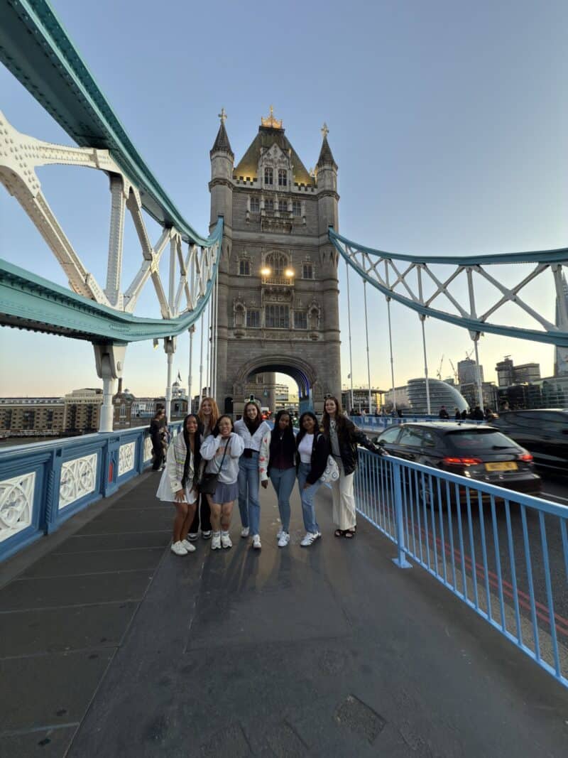 A group of travellers on Tower Bridge in London.