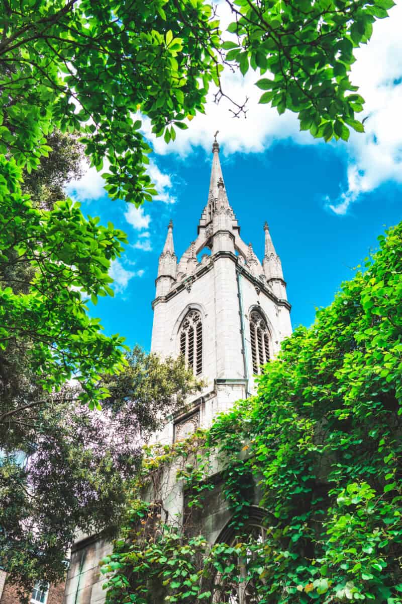 View of historic church tower near St Christopher's Liverpool Street hostel in London.