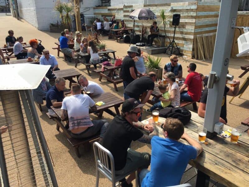 Beachfront hostel social area at St Christopher’s Newquay, Cornwall.