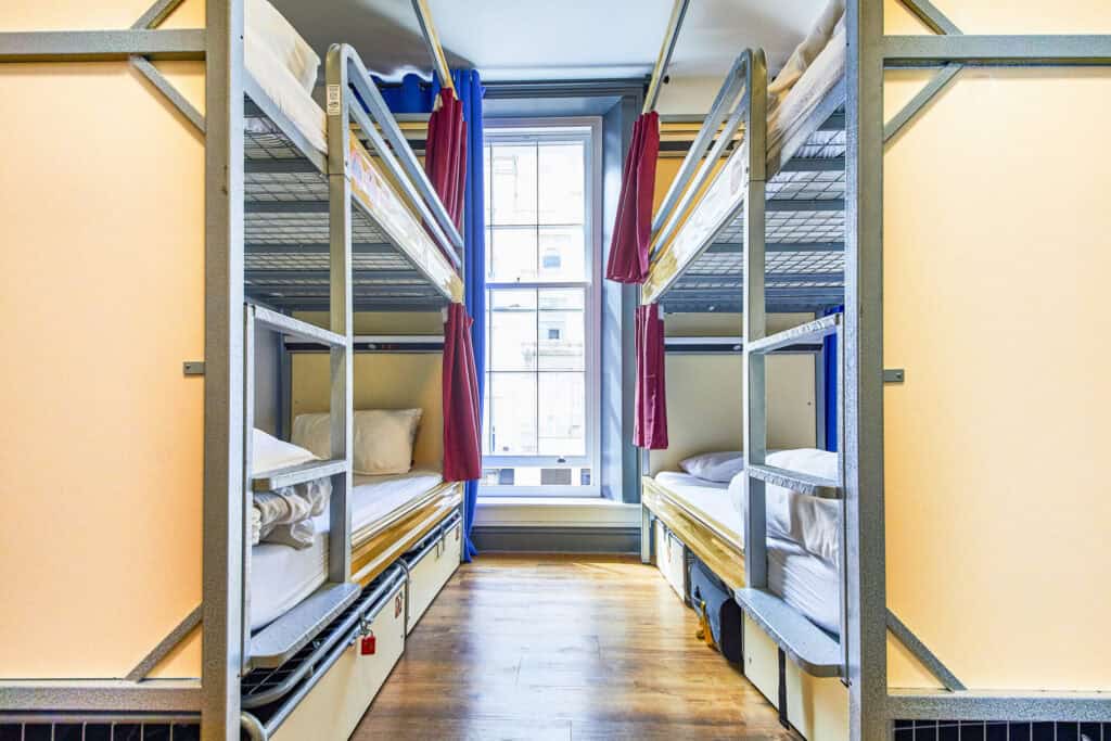 Female-only dorm room with bunk beds and a window in Shepherd's Bush Hostel.