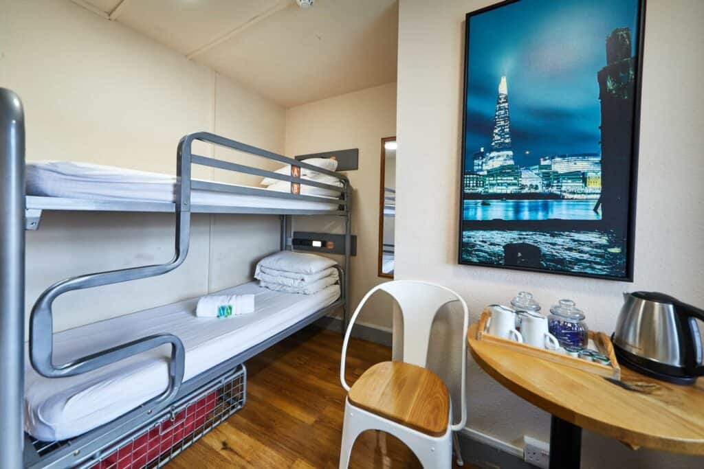 Private en suite room with bunk beds and city view poster at Shepherd's Bush Hostel.