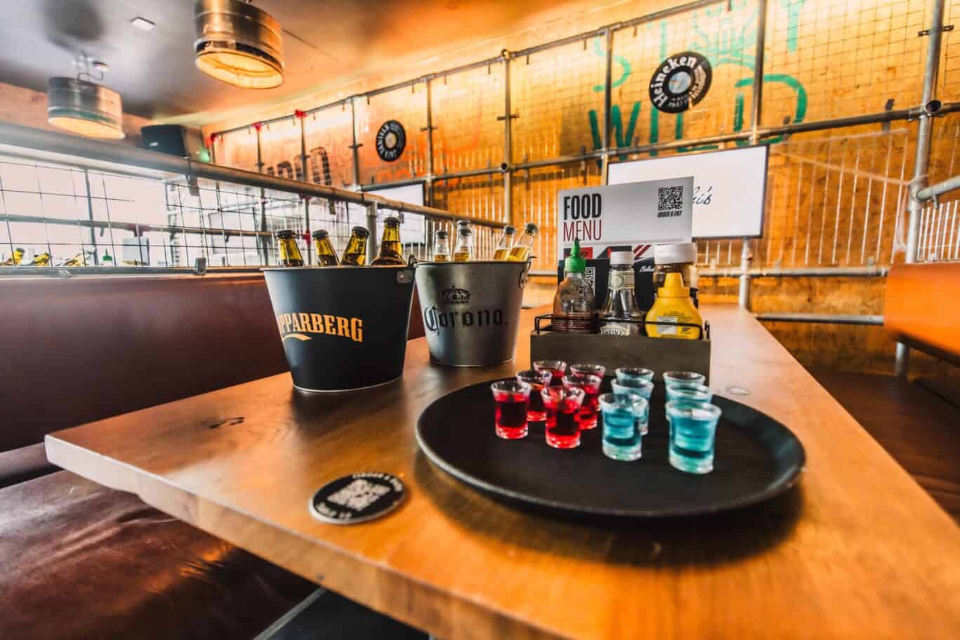 Bar table with drinks and shot glasses at Shepherd's Bush Hostel, London.