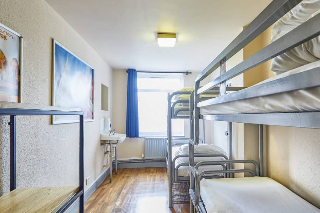 Shared dorm room at St Christopher's Shepherd's Bush hostel with bunk beds and window.