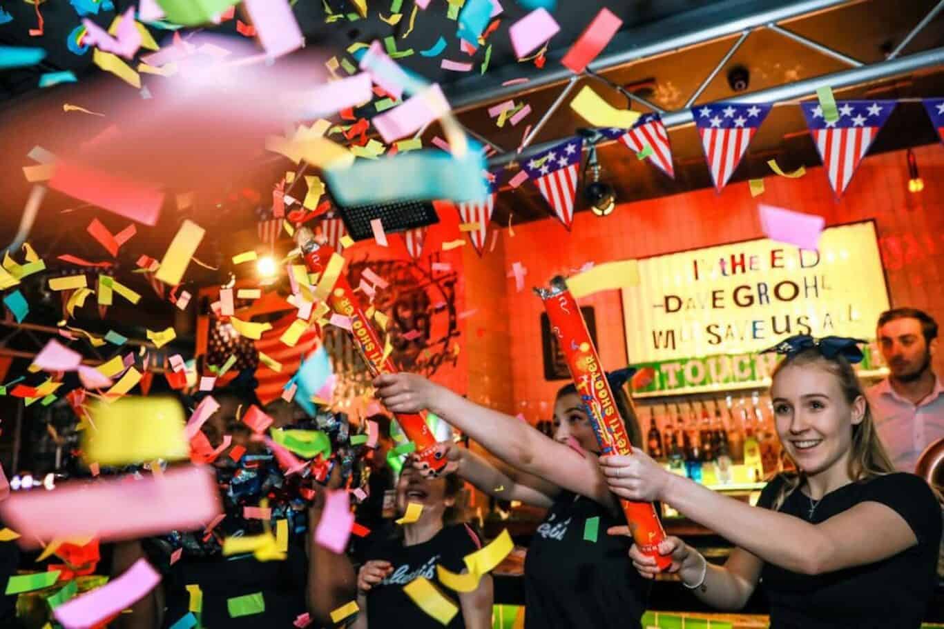 Celebratory scene at St Christopher's Shepherd's Bush Hostel with confetti and happy guests.