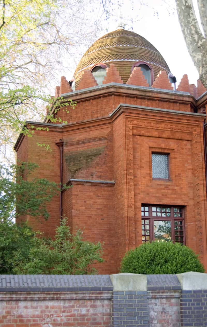 Historic red brick building with a domed roof in Shepherd's Bush, London.