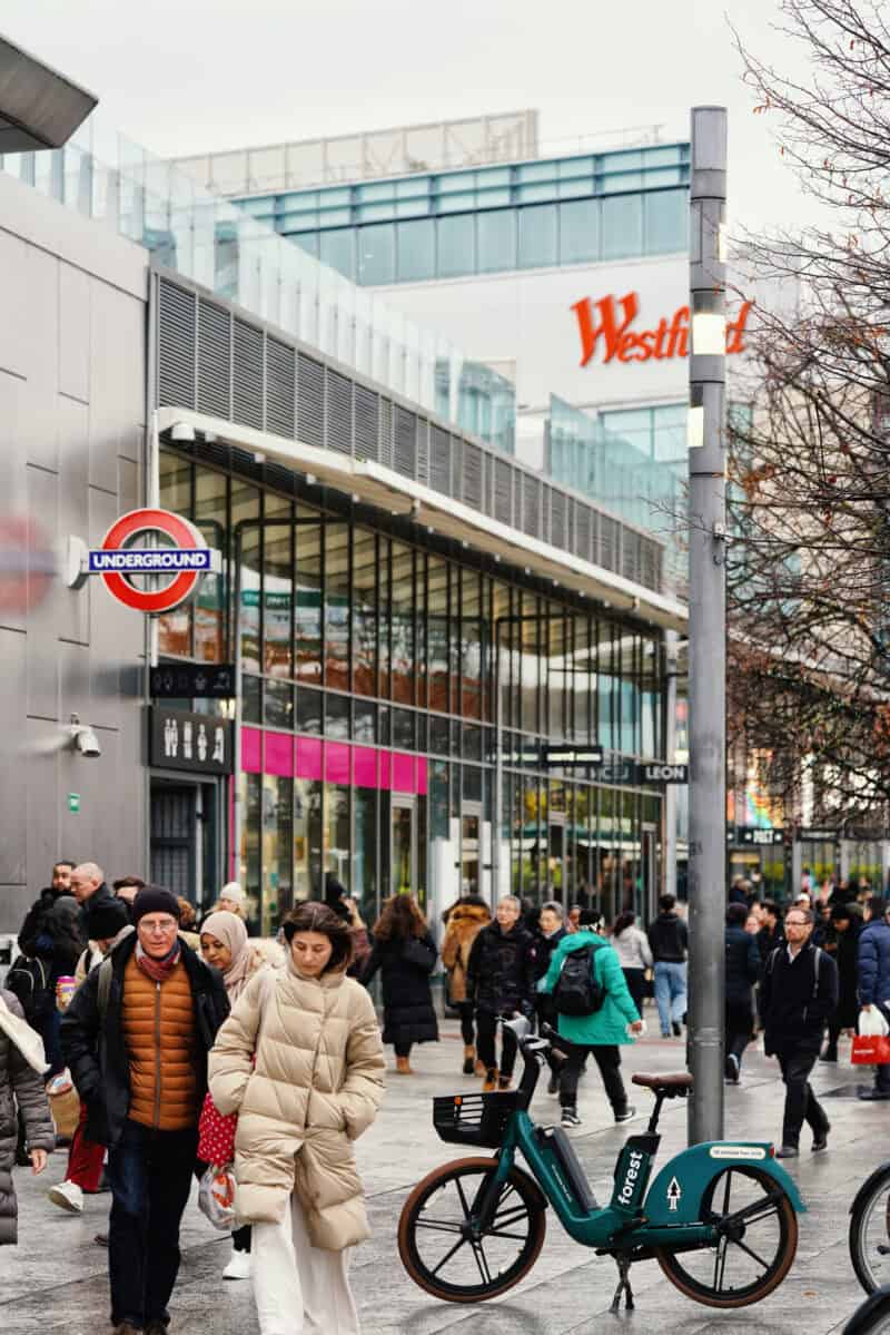 Westfield London shopping centre in Shepherd's Bush with shoppers outside.