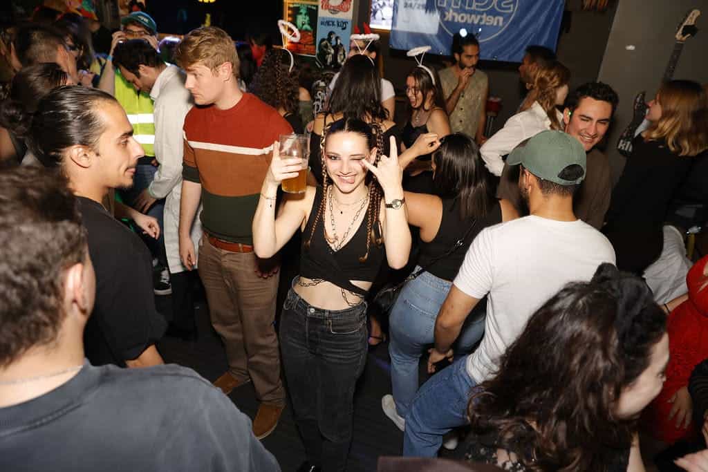 Lively social night at St Christopher’s Vienna hostel with young guests enjoying drinks and music.