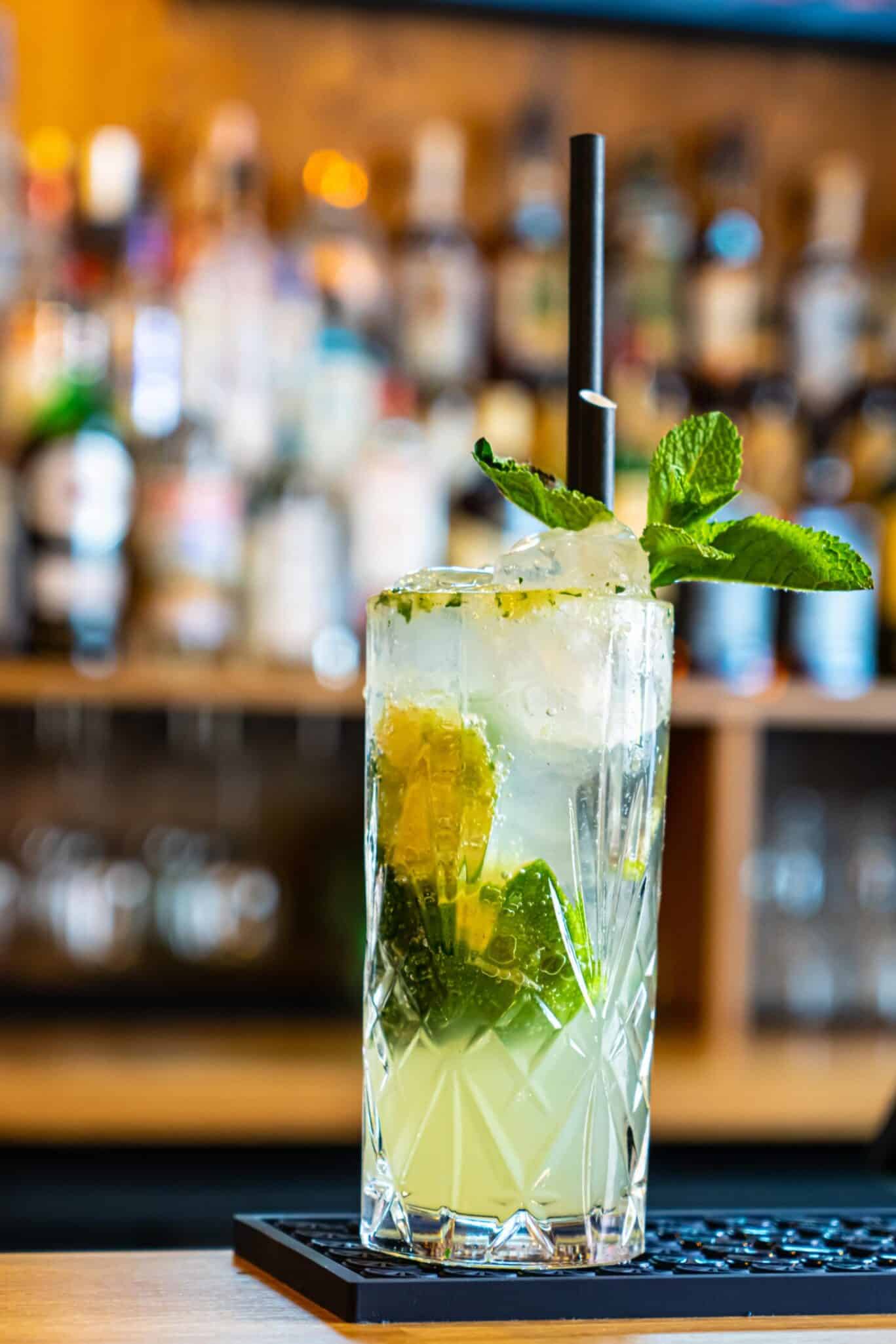 Refreshing Mojito cocktail with mint and lime at St Christopher’s Vienna hostel bar.