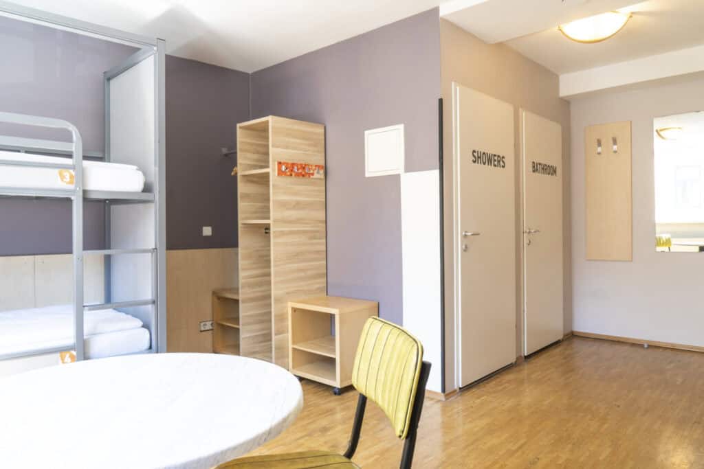 Comfortable hostel accommodation with bunk beds and communal showers at St Christopher’s Vienna.