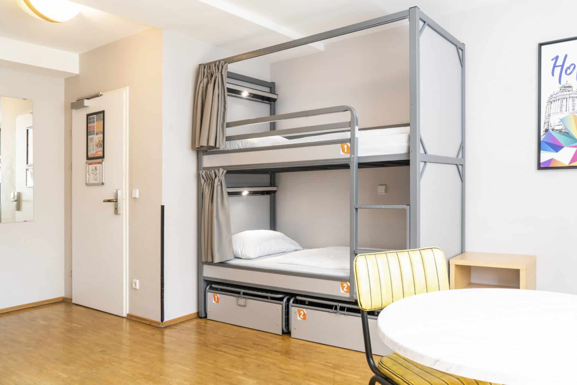 Bunk beds in a modern hostel room at St Christopher’s Vienna, featuring clean design and comfortable.