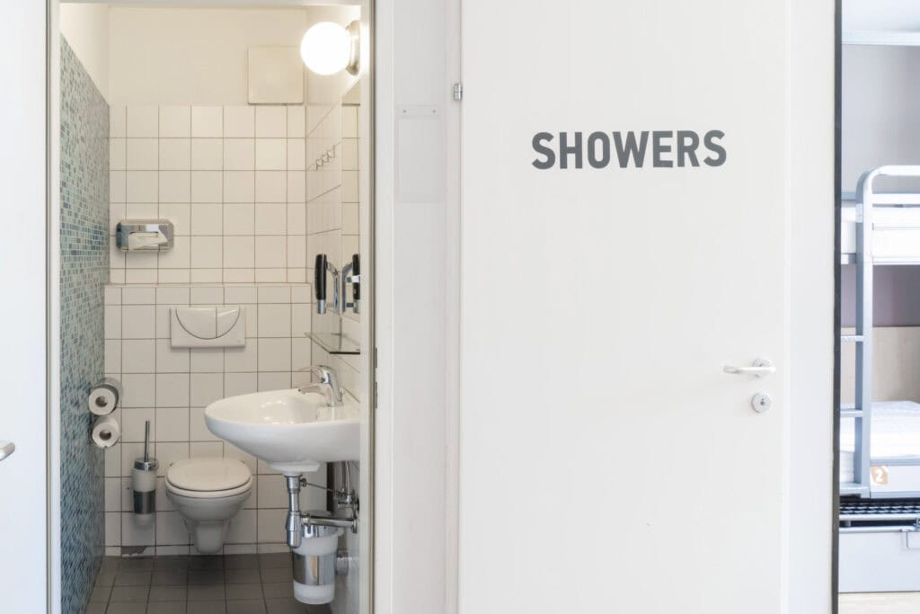 Hostel shower room with sink and toilet at St Christopher’s Vienna.