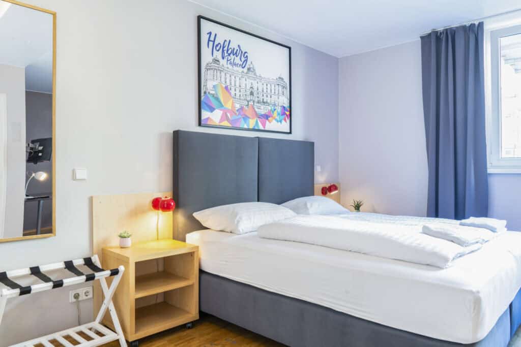 Comfortable hostel bedroom at St Christopher’s Vienna with modern decor and cosy atmosphere.