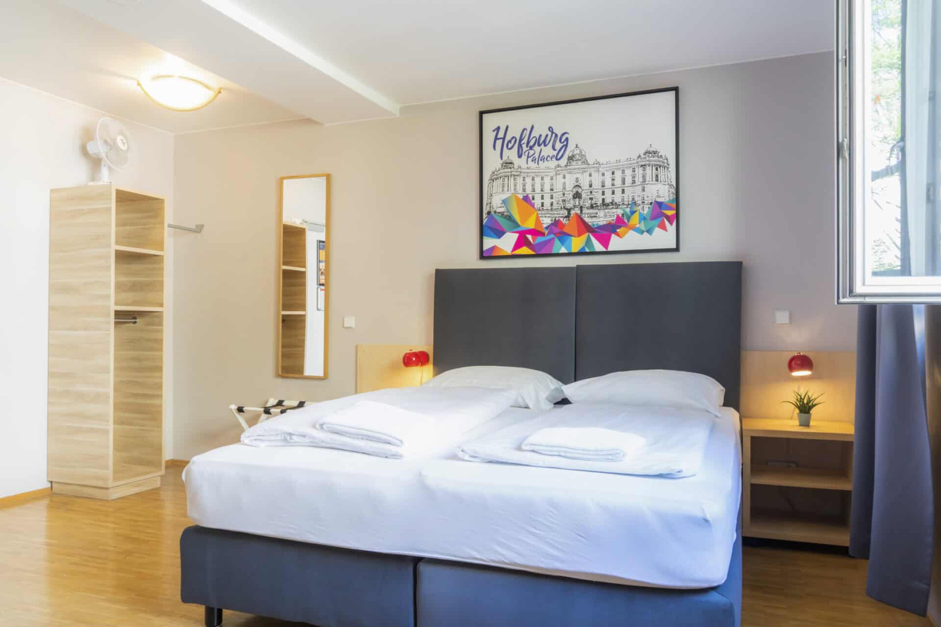 Comfortable hostel bedroom at St Christopher’s Vienna with modern decor and natural light.