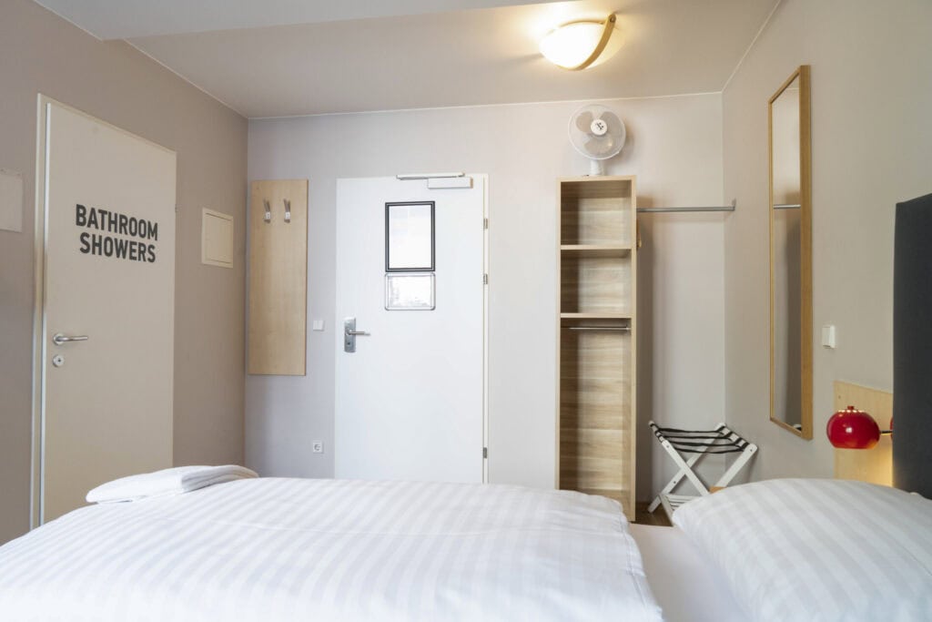 Bright hostel room at St Christopher’s Vienna with modern amenities.
