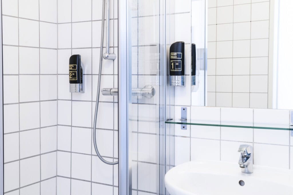 Modern hostel shower with digital controls at St Christopher’s Vienna.
