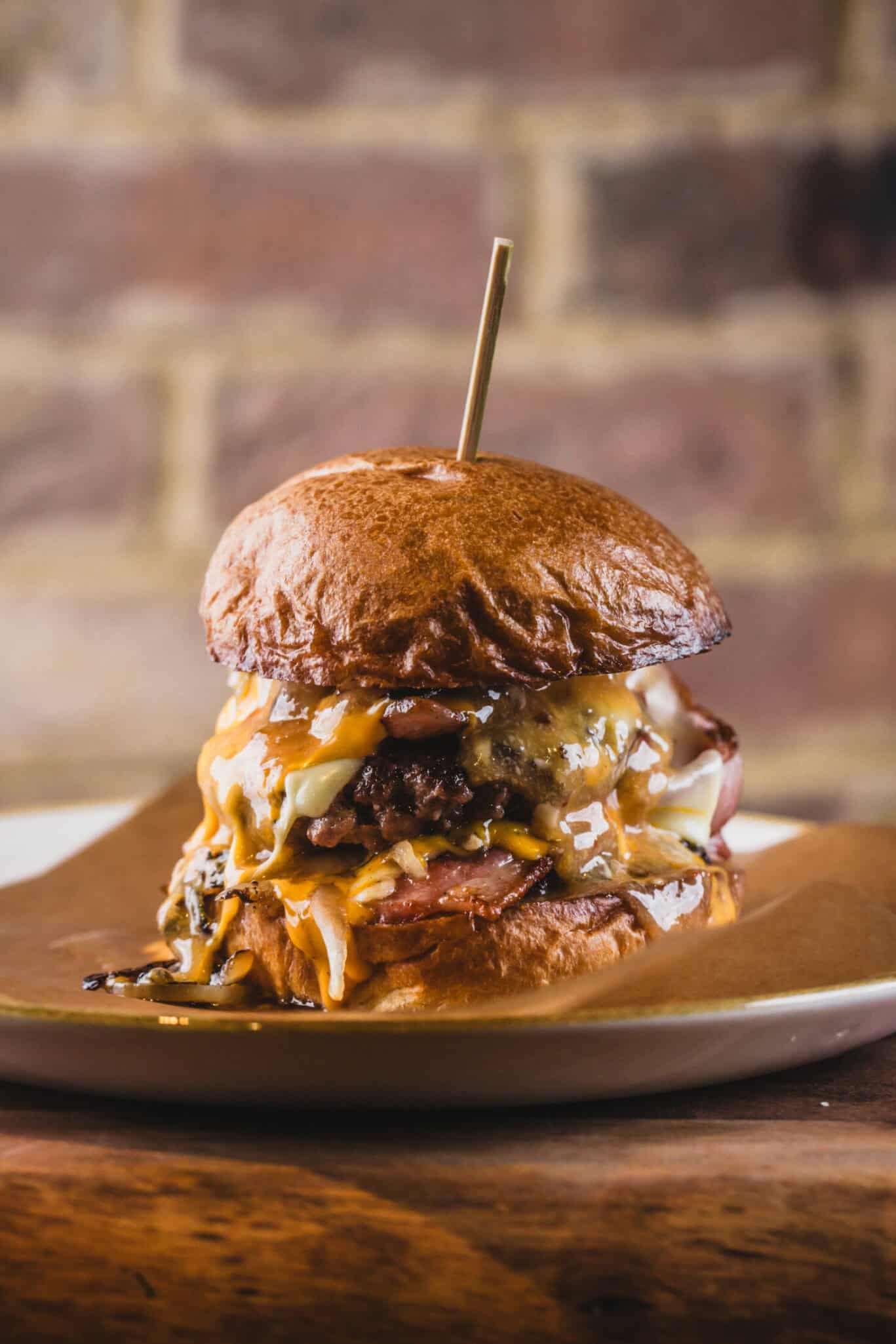 Juicy beef burger with melted cheese, crispy bacon, and fresh toppings on a toasted bun.