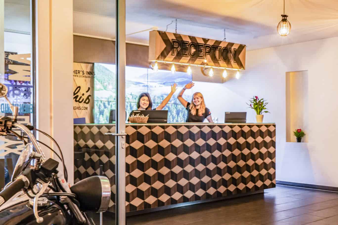 Reception area at St Christopher’s Vienna hostel with friendly staff and modern decor.