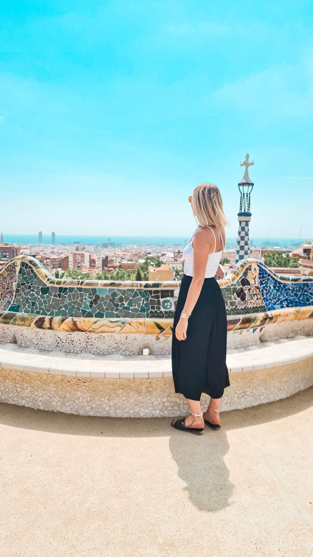 Woman enjoying panoramic view of Barcelona from Park Güell in Mitte Hostel area.