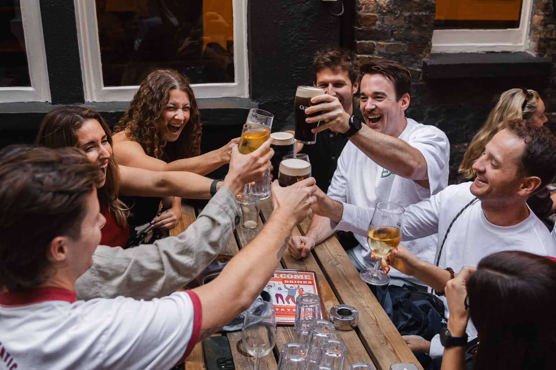 Group of friends enjoying drinks and celebrating at St Christopher's pub.