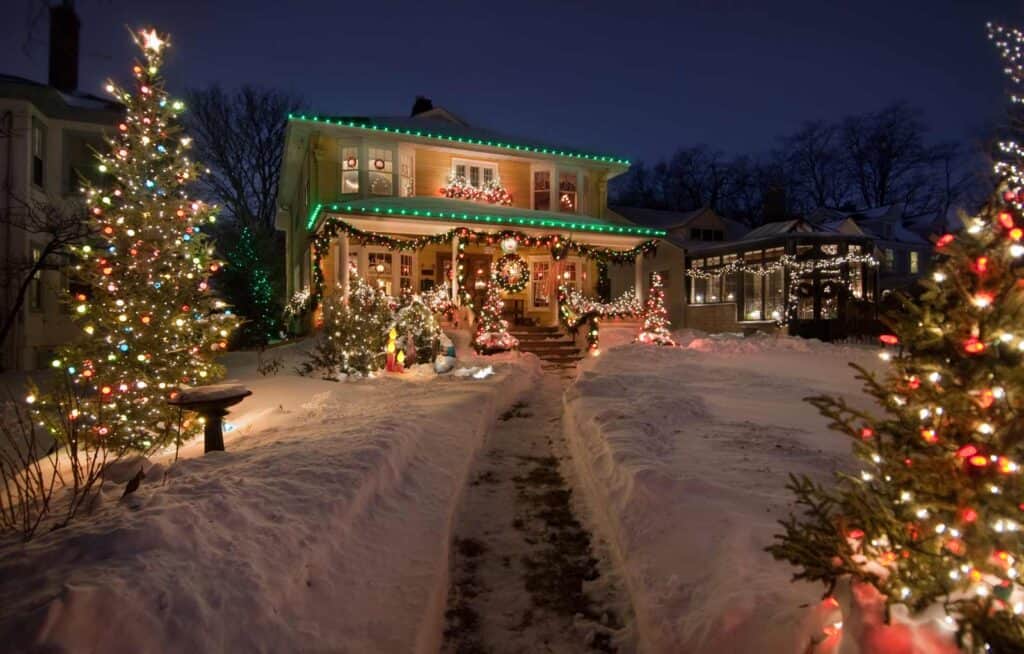 Beautifully decorated house in Berlin with Christmas lights and snow-covered garden.