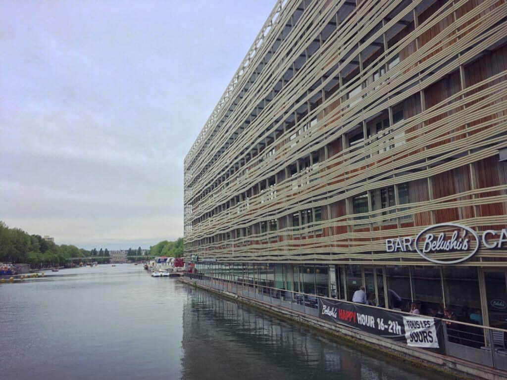 Modern hostel building along the river in Berlin's Mitte district, featuring contemporary architectu.