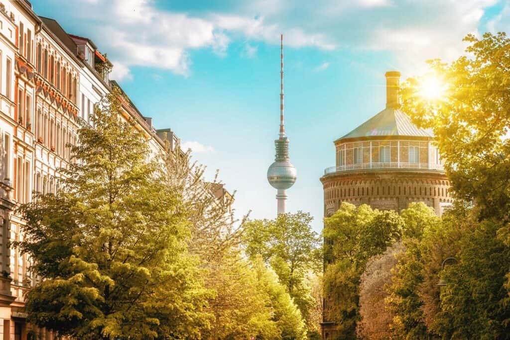 View of Berlin Mitte with TV Tower and historic architecture during sunset.