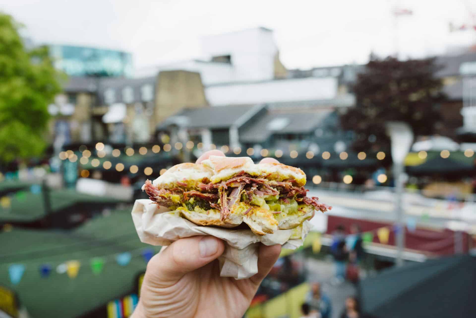 Street food sandwich at St Christopher’s Berlin - Mitte hostel, showcasing vibrant city life and loc.