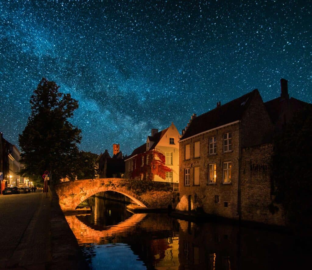 Night sky over Berlin with historic architecture and a peaceful canal scene.