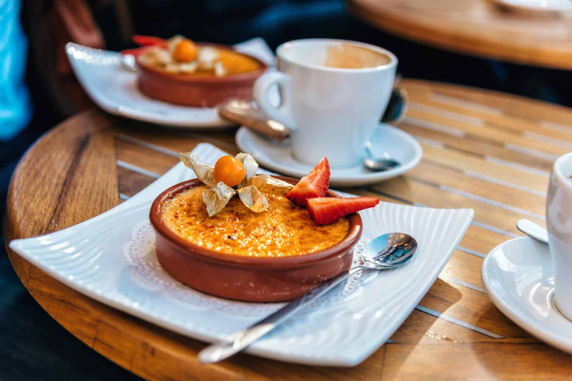 Delicious caramelised dessert with fresh strawberries and physalis, served with a cup of coffee at S.