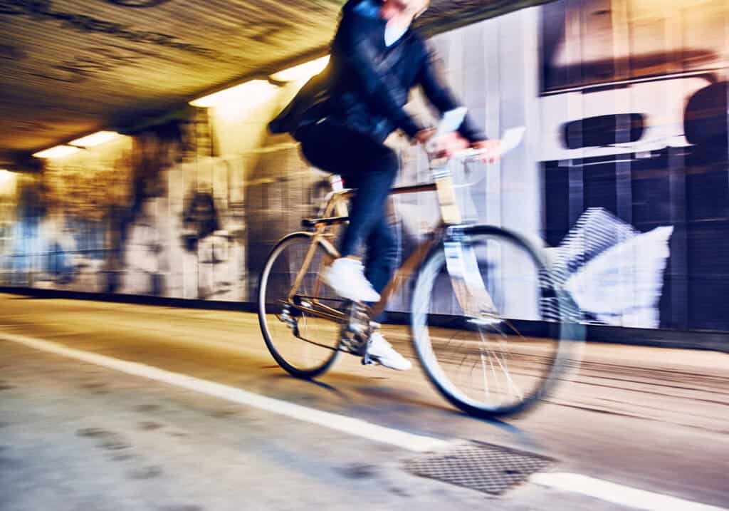 Bike rider passing through an urban tunnel in Berlin.