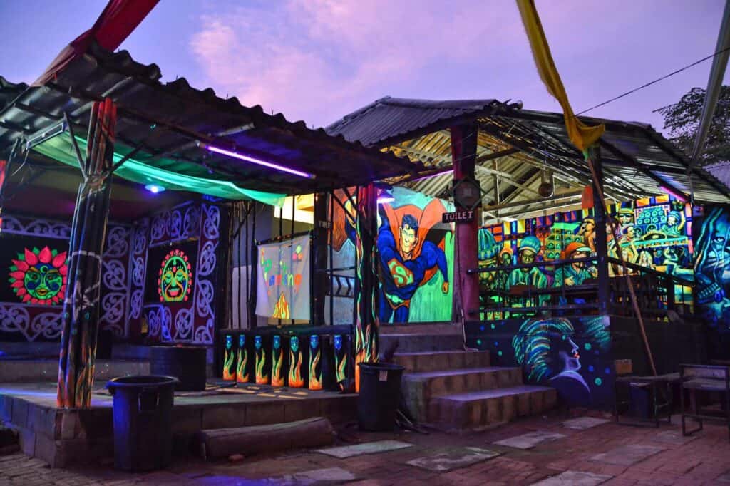 Colorful neon-lit outdoor bar with artistic murals at St Christopher’s Berlin - Mitte.