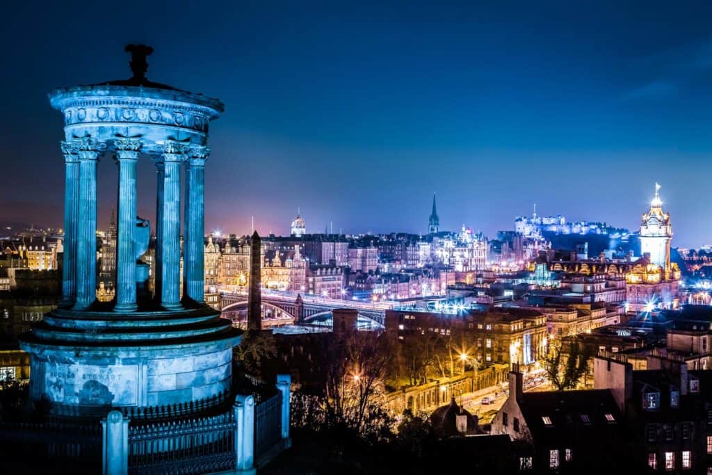 Night view of Berlin skyline from Mitte Hostel, showcasing historic monuments and illuminated citysc.